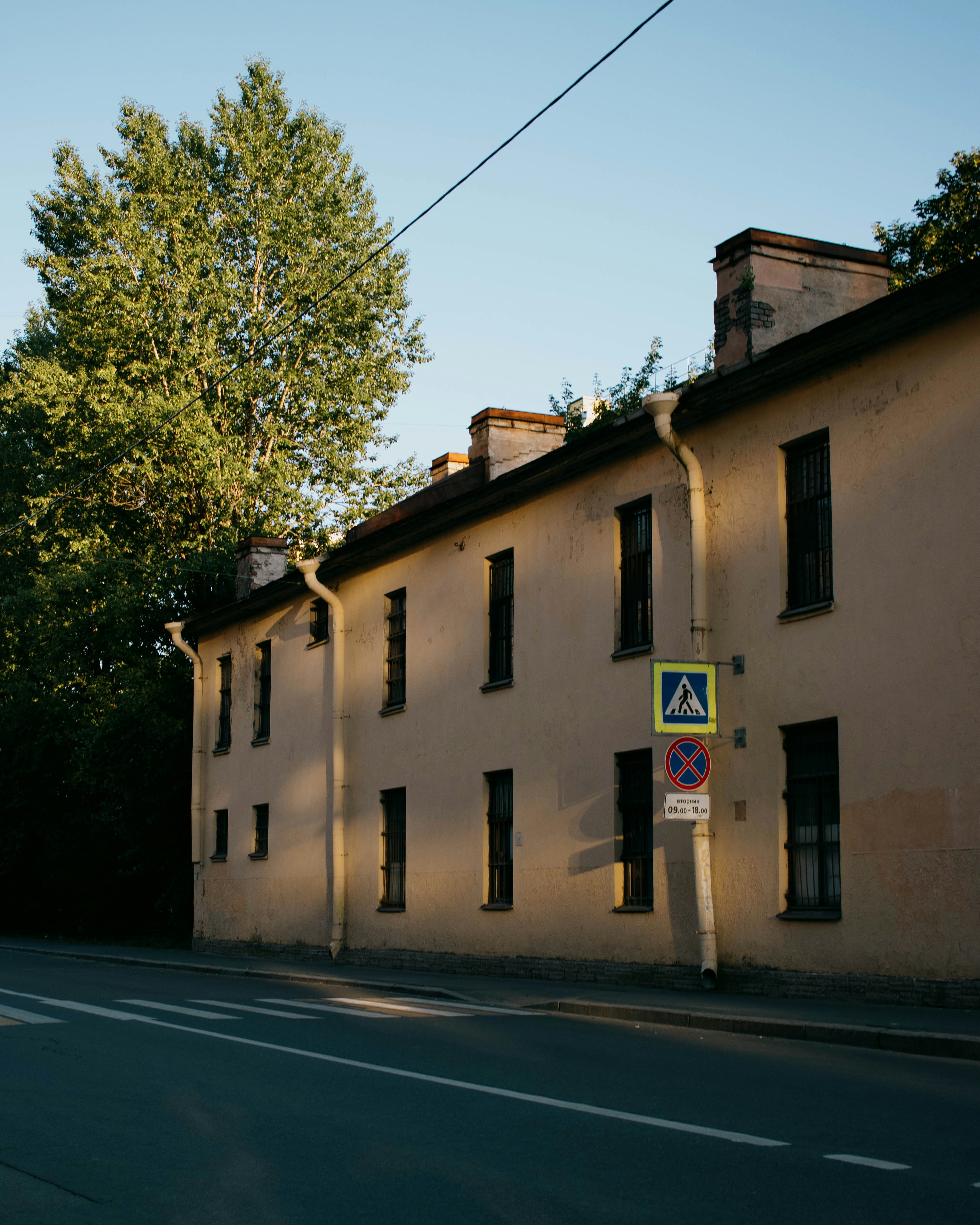 a building that has a sign on the side of a road